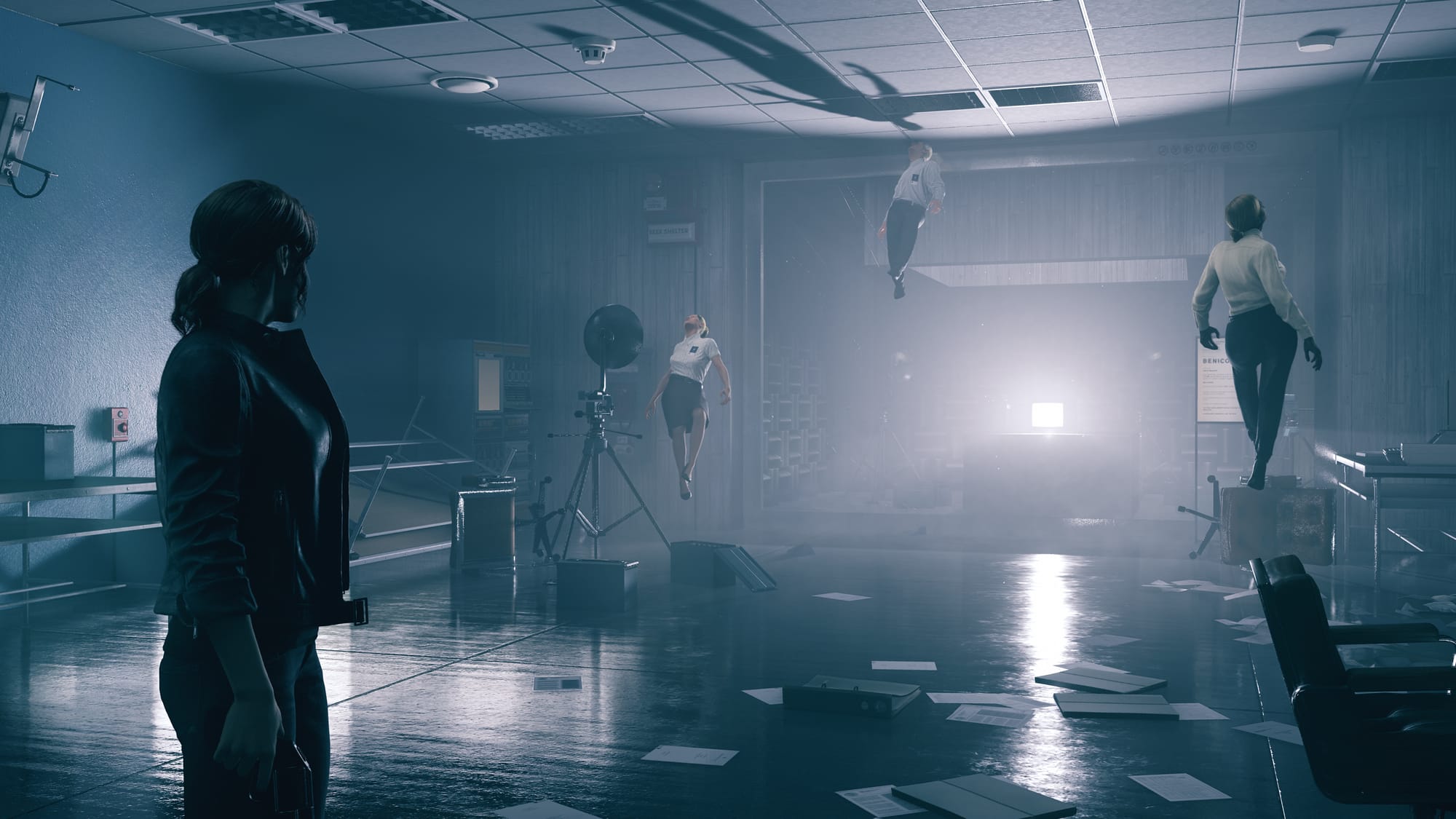 Computer game art showing a woman standing in a dark office in shambles. Several office workers float unconscious in the room.